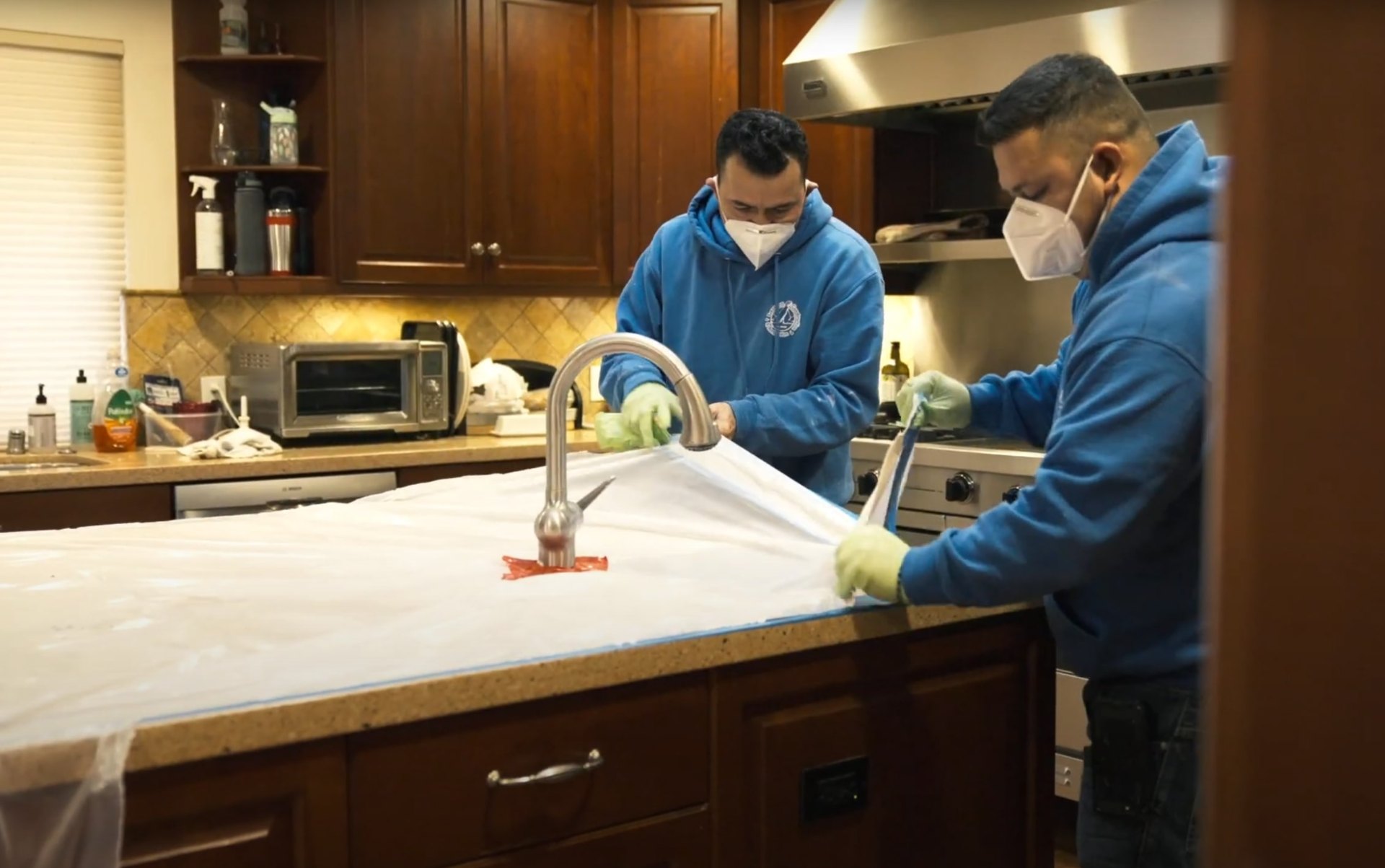 Expert water damage cleanup and sanitization services in Huntersville Professional water damage restoration technicians cleaning and sanitizing a kitchen after water damage
